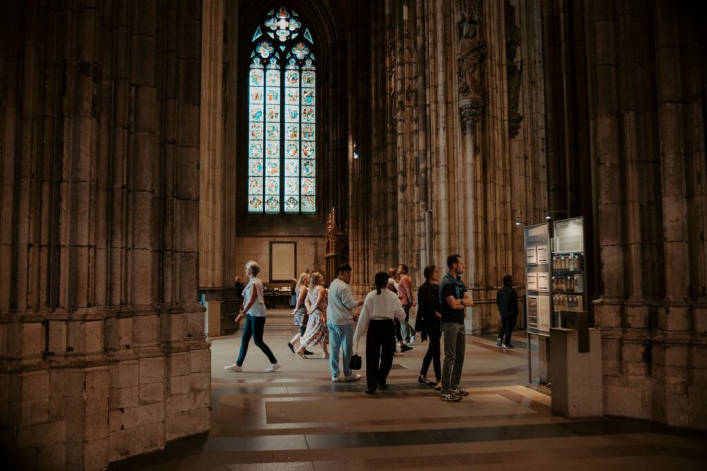 pexels photo 17841212 Visitors explore the grand gothic architecture and stained glass of a historic cathedral.